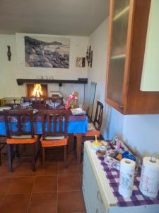 a dining room with a table and a fireplace at La ca' dal Tunec in Valduggia