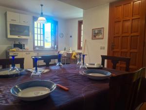 a dining room table with bowls on top of it at La ca' dal Tunec in Valduggia
