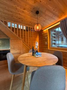 a dining room with a wooden table and chairs at La Grangette in Grimentz