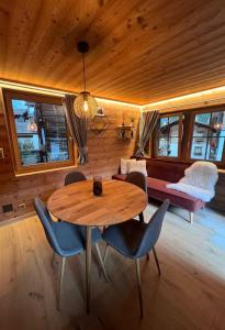 a dining room with a wooden table and chairs at La Grangette in Grimentz +17 photos
