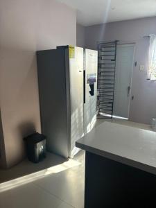 a kitchen with a counter and a trash can at Grace in Spanish Town +6 photos