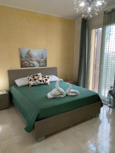 a bedroom with a bed with two towels on it at Casa Doppia G in Oliveri