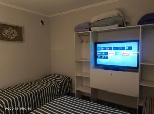 a bedroom with a bed and a tv in a room at Quincho El Solar in Corrientes