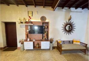 a living room with a couch and a tv at The Boho Inn in Cochin