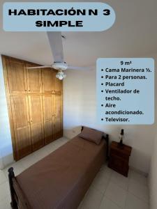 a bedroom with a bed and a wooden cabinet at Entre Montañas in Rivadavia +16 photos