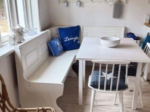 a kitchen with a white table and a white chair at 4 person holiday home in Læsø-By Traum in Læsø