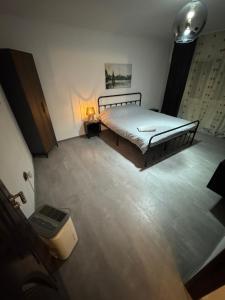 a bedroom with a bed and a lamp on the floor at HomeStars16 in Bîrlad