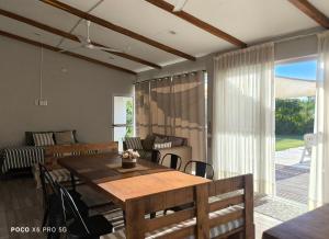 a living room with a dining room table and a couch at Quincho El Solar in Corrientes