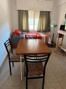 a room with a table and chairs and a bed at DepartamentoJAP in Venado Tuerto