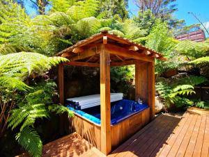 a hot tub in a wooden gazebo at Fernside Tranquil Retreat in Pauanui
