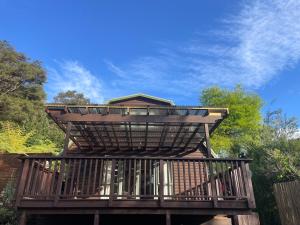 a wooden deck with a roof on top of it at Fernside Tranquil Retreat in Pauanui