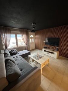 a living room with a couch and a table at Apartmani VRELO in Krašići