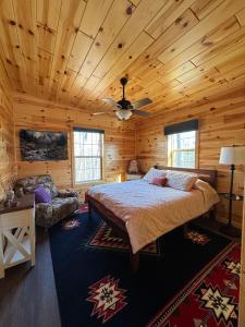 a bedroom with a bed in a wooden cabin at Hedgehog Hill Cabin-Helen Hideaway in Clarkesville