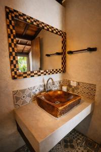 a bathroom with a wooden sink and a mirror at Varanda do Mar Caraíva Oceanfront in Porto Seguro +37 photos