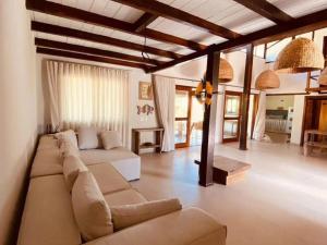 a living room with a couch and a table at Varanda do Mar Caraíva Oceanfront in Porto Seguro