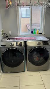 a stove and a microwave in a kitchen with a window at warm house2 in Coquitlam