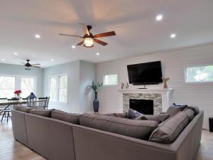 a living room with a large couch and a flat screen tv at The Sunrise On Sunset in West Cape May