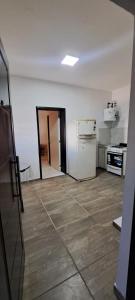 an empty room with a kitchen with a stove and refrigerator at Apartment for 2 people - Jorge One in Adrogue