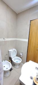 a bathroom with a toilet and a sink at Apartment for 2 people - Jorge One in Adrogue