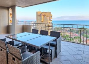 a balcony with a table and chairs and the ocean at Bella Sirena Resort Stellar View C601 in Puerto Peñasco