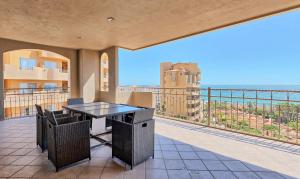 a balcony with a table and a view of the ocean at Bella Sirena Resort Stellar View C601 in Puerto Peñasco