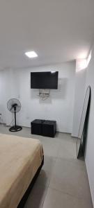 a bedroom with a bed and a flat screen tv at Apartament for 2 people - Jorge Two in Adrogue