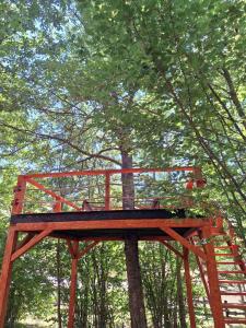 a wooden tree house in the middle of a forest at Forest Rhapsody Brezna in Plužine