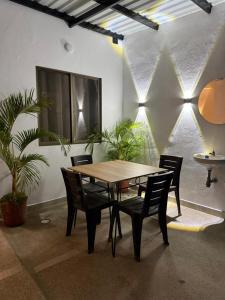a table and chairs in a room with plants at Tierra Dulce - Casa Turística in Villeta
