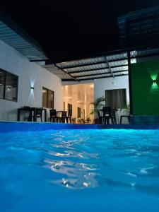 a swimming pool with blue water in a house at Tierra Dulce - Casa Turística in Villeta