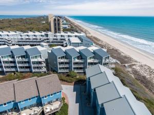 an aerial view of a beach with blue condos at Tranquility By The Sea-Oceanside Condo in Salter Path