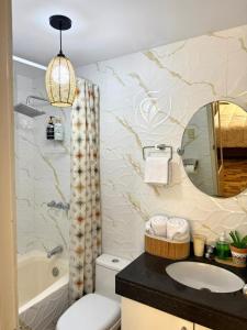a bathroom with a toilet and a sink and a mirror at City Center Lima in Lima +3 photos