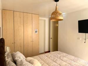 a bedroom with a bed and a pendant light at City Center Lima in Lima