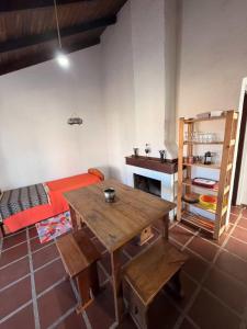 a living room with a wooden table and a couch at Mar y Sal in Punta Del Diablo
