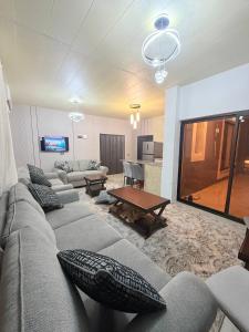 a living room with a couch and a table at Suf Hills Cabin in Jerash