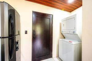 a brown door in a kitchen with a washer and dryer at Mountain Whisper in Tilarán