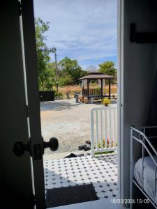 an open door with a gate and a gazebo at Zaifaa Beach Inn in Setiu
