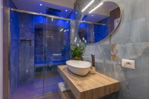 a bathroom with a sink and a large mirror at Maison 900 in Tivoli +35 photos