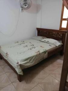 a bed in a room with a bedspread on it at Casa madrigueña rincón del mar in Rincón
