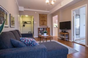 a living room with a couch and a tv at Apartment Savonkatu 25 in Kuopio