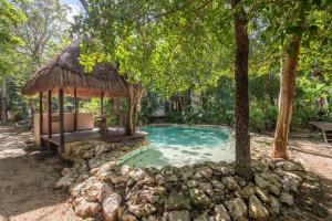 a swimming pool with a gazebo in a yard at Private Jungle Villa with Full Kitchen & Pool Access in Tulum