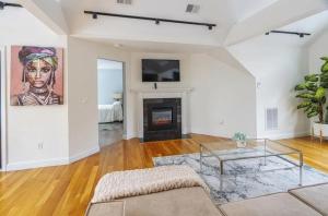 a living room with a glass coffee table and a fireplace at GorgeousWestwood in Westwood
