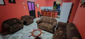 a salon with chairs and a clock in a room at Casa de Lewis in San Cristóbal
