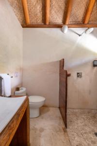 a bathroom with a toilet and a sink at Luxury Jungle Suite with Private Jacuzzi & Cenote Pool View in Chemuyil +19 photos