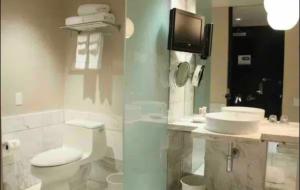 a bathroom with a toilet and a sink at Palms Place Condo with strip view in Las Vegas