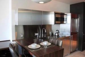 a kitchen with a wooden island with a counter top at Palms Place Condo with strip view in Las Vegas