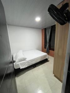 a bedroom with a bed and a ceiling fan at El Rincon de Teresita in Villavicencio +1 photo