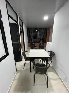 a dining room with a white table and chairs at El Rincon de Teresita in Villavicencio