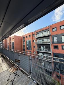 a balcony with a bench on top of a building at Advent House Ancoats Hosted Apartment in Manchester