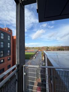 a balcony with a view of a parking lot at Advent House Ancoats Hosted Apartment in Manchester