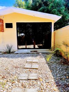 a building with a large window in a yard at Casa Brisas in Puerto Escondido